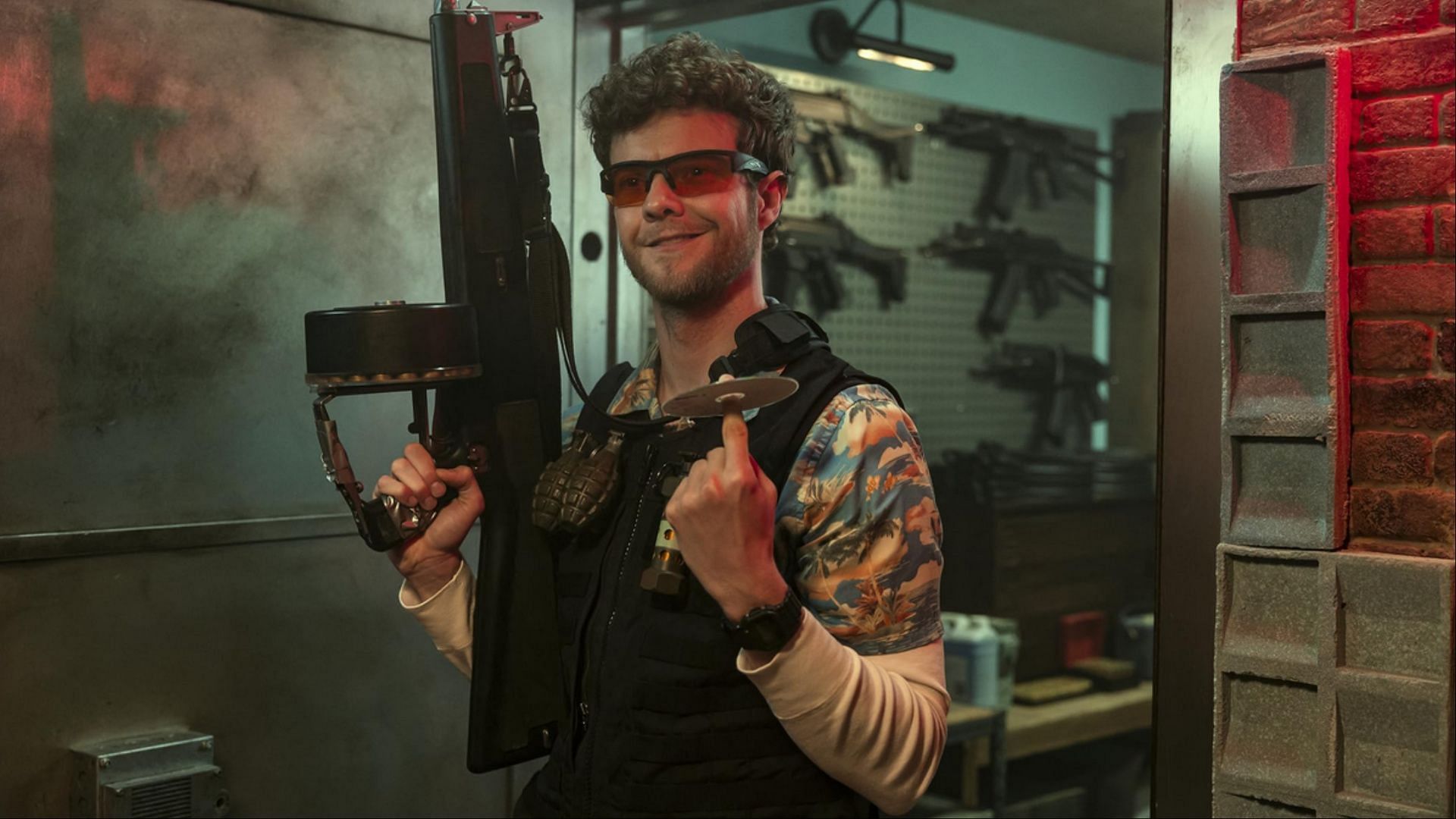 Jack Quaid returns as CIA agent Marty Comer in Heads of State, pictured armed and prepared inside his Warsaw safehouse (Image via Amazon Prime)
